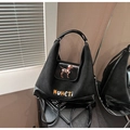 Detail of matte and patent leather patchwork on a black backpack with dog embroidery - Black