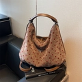 Bruine hobo tas met rode stippen, zilveren strikdetail en luxe leren afwerkingen - Bruin