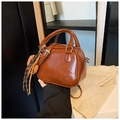 Brown high-gloss leather crossbody mini bag with adjustable strap and decorative knot - Brown
