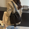 Classic black matte bucket bag with drawstring closure and stylish fringe details - Black
