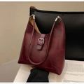 Close-up of burgundy leather tote with geometric stitching and silver buckle detail - Ankara Red