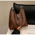 Detail of vintage brown shoulder bag with geometric stitching and silver buckle accent - Coffee