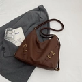 Dark brown leather shoulder bag with pebbled texture and gold buckles on a grey blazer - Coffee (No Pendant)