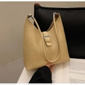 Detail of beige tote bag with geometric patchwork stitching and silver buckle accent - Khaki