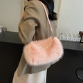 Pink plush shoulder bag with pearl chain detail shown on model for autumn winter style - Pink