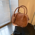 Vintage brown suede handbag with adjustable crossbody strap and golden fashion text - Brown