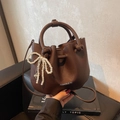 Brown pleated bucket bag with pearl bow charm and drawstring closure in retro style - Coffee