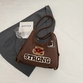 Deep brown tote bag with bear embroidery and white STRONG lettering on a grey blazer - No Pendant / Coffee