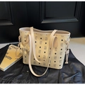 Detailed view of beige tote bag with bear pattern placed on a black leather jacket - Off-white (With Pendant)