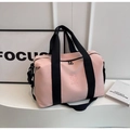 Detail of pink travel bag showing NINGJIA logo, nylon fabric and black handle - Pink
