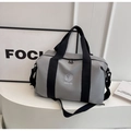 Detail of grey travel bag with durable fabric, wide black straps and branded logo - Gray