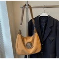 Detailed view of ginger yellow suede crossbody bag with silver chain and M buckle - Orange