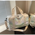 Iridescent pearlescent travel bag showing waterproof fabric and adjustable shoulder strap - Off White