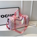 Close-up of holographic travel bag showing pink pearlescent fabric and side compartment - Pink