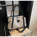 Détail du sac de voyage en toile beige avec bordure noire et bandoulière amovible - Noir