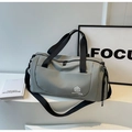 Close-up of grey waterproof travel bag featuring dual handles and adjustable shoulder strap - Gray
