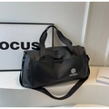 Detail of black waterproof travel bag with reinforced handles and NINGJIA logo - Black