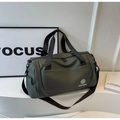 Detail view of dark green waterproof travel bag with double zipper and front pocket - Green