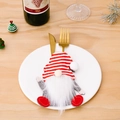 Christmas gnome cutlery holder with red and white striped hat on a white dinner plate - Red And White Striped Hat Style