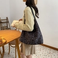 Vintage leopard print tote bag with black leather shoulder strap in a cozy indoor setting - Gray