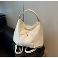 Detail view of beige tote bag featuring white plush animal motif and red accents - Puppy Creamy White