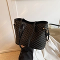 Black tote bag with repeating NK monogram print and elegant gold metal ring detail - Black