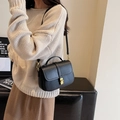 Elegant black pebble leather handbag with gold square twist lock and top handle - Black
