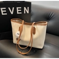 Large cream tote bag with tan leather trim and a playful fluffy eye charm detail - Cream White With Pendant
