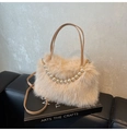 Detail of fluffy faux fur handbag in apricot with elegant pearl handle and slim strap - Light Khaki