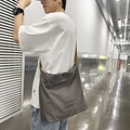 Dark grey large canvas crossbody bag with adjustable brown strap and text print - Gray