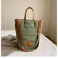 Grass green quilted puffer bucket bag with brown leather handles and shoulder strap - Green
