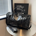 Black glossy patent leather duffel bag with dual handles and adjustable shoulder strap - Black