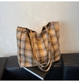 Detail of yellow checkered tote bag with large capacity on a leather bench - Khaki Plaid
