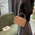 Umhängetasche in Retro-Braun mit doppelten Reißverschlüssen und Nieten auf grünem Sofa - PU / Braun