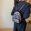 Mini backpack for women featuring grey leopard print pattern and metal zipper detail - Black