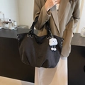 Black canvas tote bag with metal rivets and a cute white cloud pendant on the handle - Black