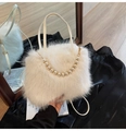 Detailed macro of white faux fur handbag texture with elegant pearl chain and hardware - White