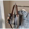 Detail of canvas tote bag with vertical stripes and a cute plush bunny charm - Gray With Pendant