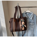 Detailed shot of striped canvas tote bag with brown straps and cute rabbit charm pendant - Coffee with Pendant