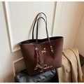 Detail of dark brown suede tote bag featuring dog embroidery and a dachshund charm - Coffee with Pendant