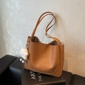 Brown litchi leather tote bag with slim straps and a plush white cloud charm - Brown
