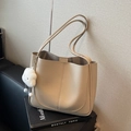 Versatile beige pebbled leather shoulder bag with a cute cloud plush charm accessory - Off White