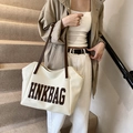 Creamy white large tote bag with HNKBAG logo and brown straps in chic minimalist style - White