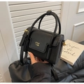 Detail of black leather square bag featuring golden PAN'TOR logo and metallic D-ring - Black
