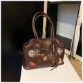 Vue détaillée du sac cabas en similicuir marron avec badges brodés et détails vintage - Avec Pendentif / café