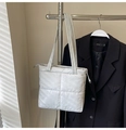 Detail of light gray quilted puffer tote bag with metallic finish and top zipper closure - Light Gray