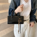 Glossy black leather handbag with gold star charm and colorful woven tassel detail - Black with Pendant