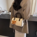 Beige Boston bag with brown round handles and cute bear charm, elegant crossbody style - With Pendant / Off White