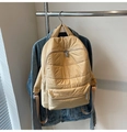 Macro view of beige quilted nylon backpack featuring horizontal stitching and zipper detail - Khaki