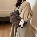 Chic leopard print tote bag with V-shaped opening and black leather straps for daily commute - Coffee